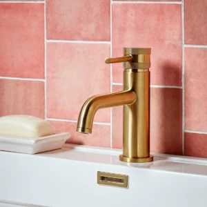 Front view of Scudo Core brushed brass round mono basin mixer tap with lever handle, brushed brass finish, brass construction and deck mounted installation.